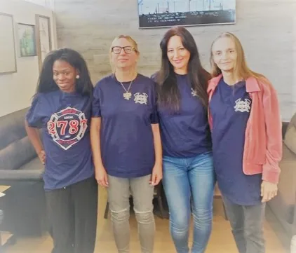 Four staff members in matching firefighters' union campaign shirts