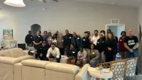 Large field team assembled indoors for a campaign briefing